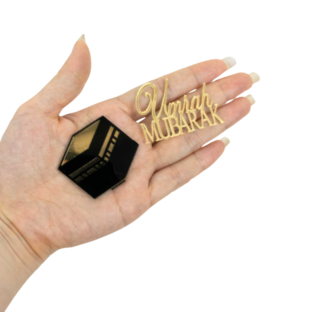 image of umrah mubarak and kabah acrylic cake topper held in hand