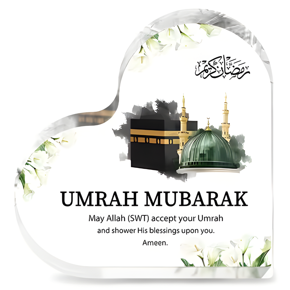 Heart-shaped plaque with Islamic architecture and 'Umrah Mubarak' text.
